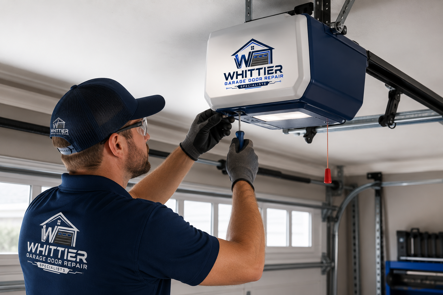 Technician repairing a garage door opener in Whittier